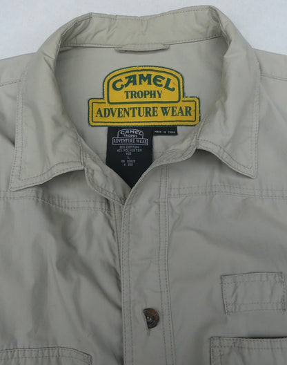 Close-up of a light khaki Camel Trophy Adventure Wear button-up shirt showing the inner collar label and chest pocket.